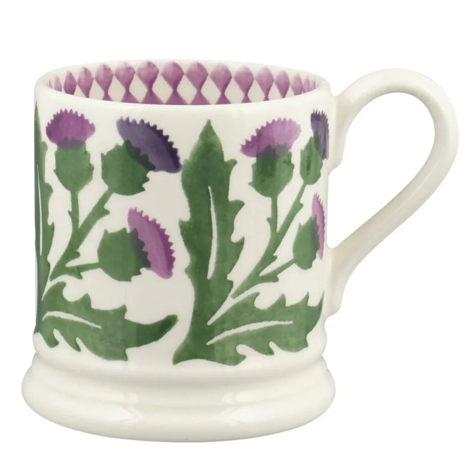 White mug with purple and green floral design on a white background