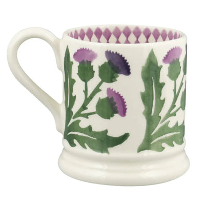Ceramic mug with purple and green floral design on a white background