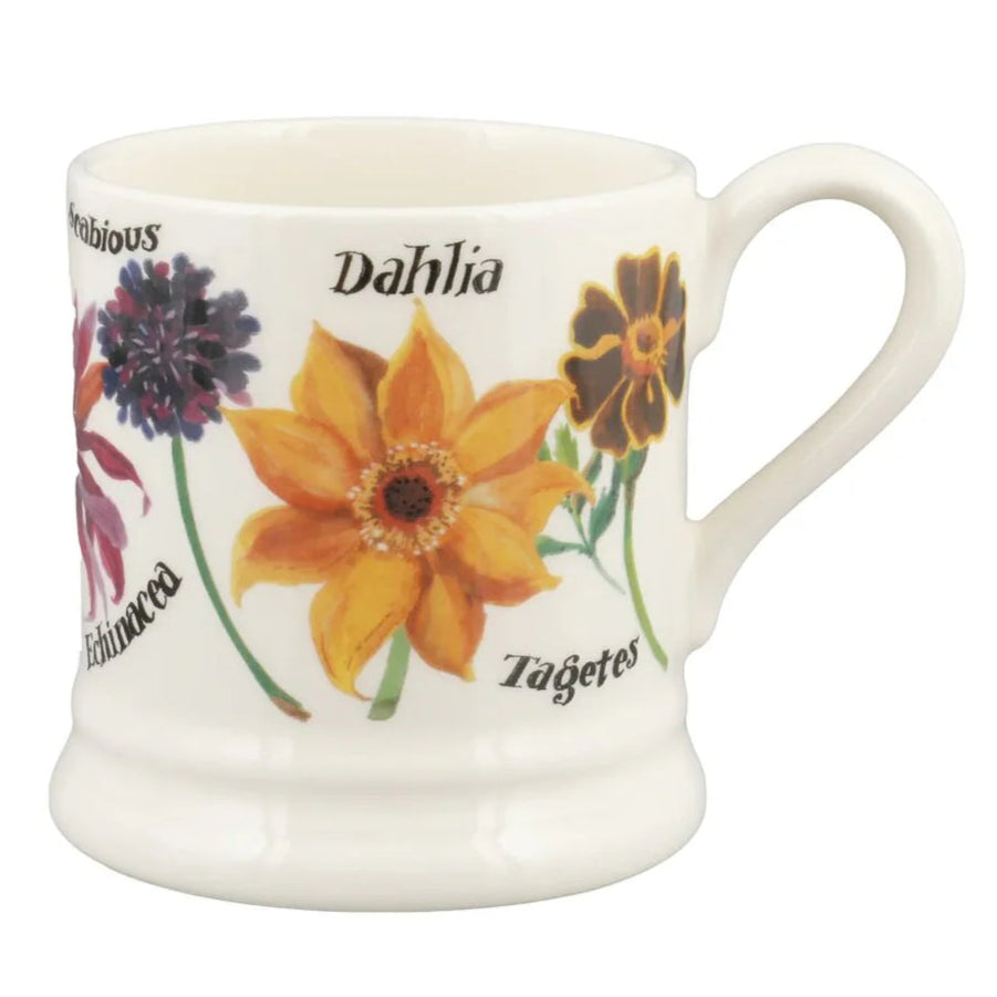 Ceramic mug with floral design and text on a white background
