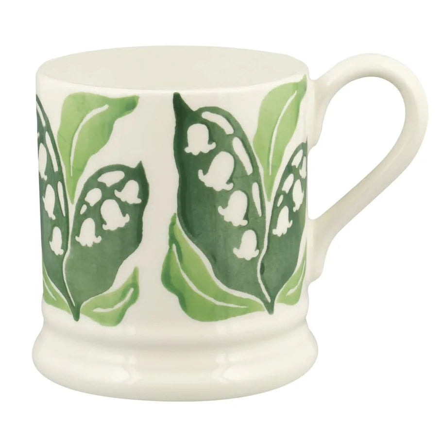 White mug with green leaf pattern on a white background
