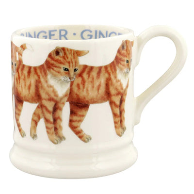 A white ceramic mug featuring a printed illustration of three ginger cats and the word 'GINGER' in blue text around the inner rim, shown on a plain white background.
