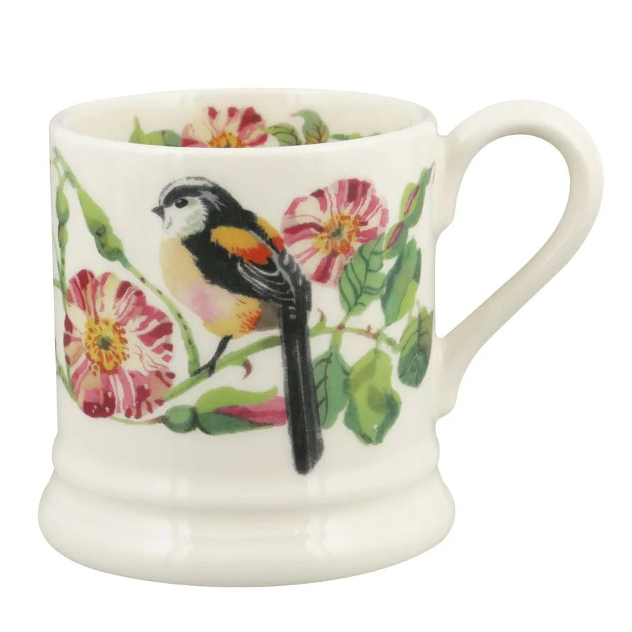 White mug with a bird and floral design on a white background