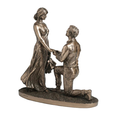 Bronze statue of a man proposing to a woman on a white background